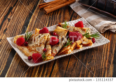 Sweet homemade pancakes with raspberry Sweet homemade pancakes with raspberry 135114337