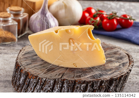 Yellow maasdam cheese triangle piece 135114342