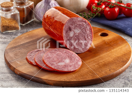 Ham sausage with slice over board 135114343