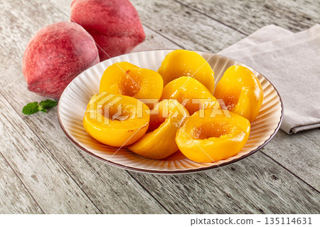 Sweet ripe yellow canned peaches 135114631