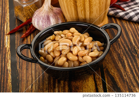 Baked white canned beans in the bowl 135114736