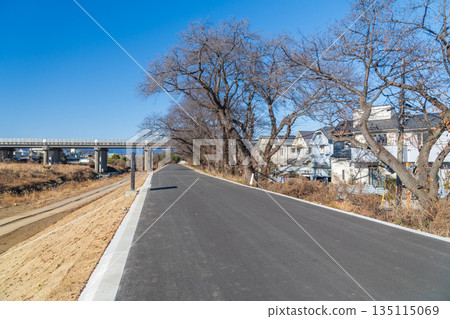A 5-meter-wide promenade built over the river next to a house 135115069