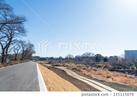 A 5-meter-wide promenade built over the river next to a house 135115070