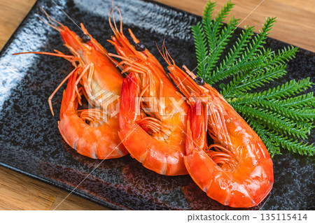Boiled shrimp served on a black square plate 135115414