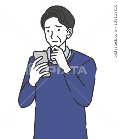 A middle-aged man worried while looking at his smartphone 135115810