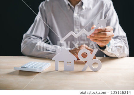 Person evaluates house property market, holding rising arrow showing growth, assessing real estate mortgage interest rates and loan percentage for successful investment 135116214