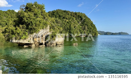 Transparent sea and coastal island seen from the sidewalk. Tropical nature background during the day Transparent sea and coastal island seen from the sidewalk. Tropical nature background during the day 135116595