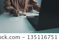 User working on a laptop with AI technology, finger pointing at artificial intelligence interface. Concept of technology, internet, innovation, smart working, digital transformation, automation, and f 135116751