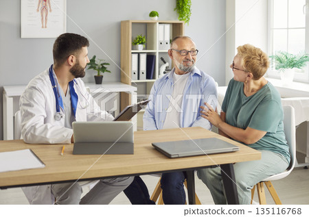 Doctor explaining medical results to senior elderly couple during health consultation 135116768