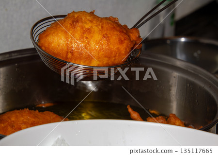 Frying doughnuts for new years eve 135117665