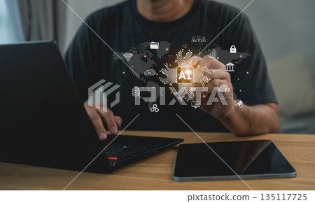 Businessman touching virtual AI chip processor on global network interface while using laptop. Concept of artificial intelligence technology, digital transformation, and future connection. 135117725