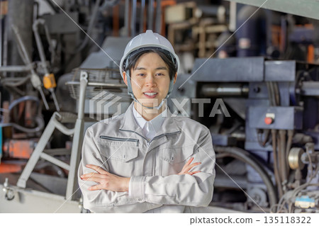 Young male worker working in a factory Young male worker working in a factory 135118322