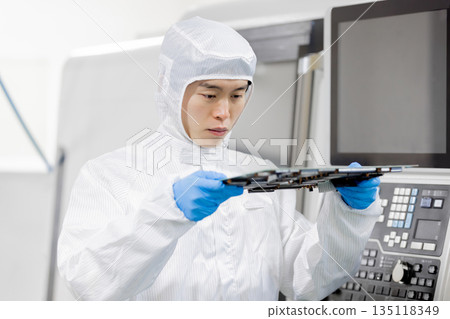Workers inspecting products in a factory Workers inspecting products in a factory 135118349