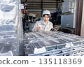A male worker inspecting ingots at a factory 135118369