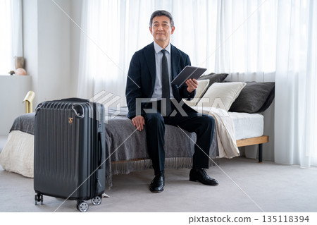 Senior men using accommodation facilities for travel or business trips 135118394