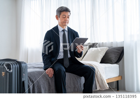 Senior men using accommodation facilities for travel or business trips 135118395