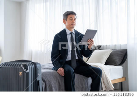 Senior men using accommodation facilities for travel or business trips 135118396