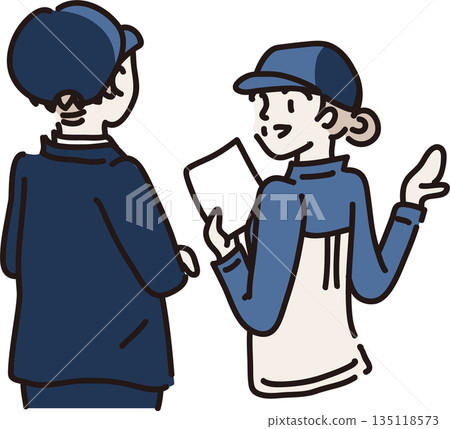 A woman wearing a hat and blue work clothes explaining to a visitor A woman wearing a hat and blue work clothes explaining to a visitor 135118573