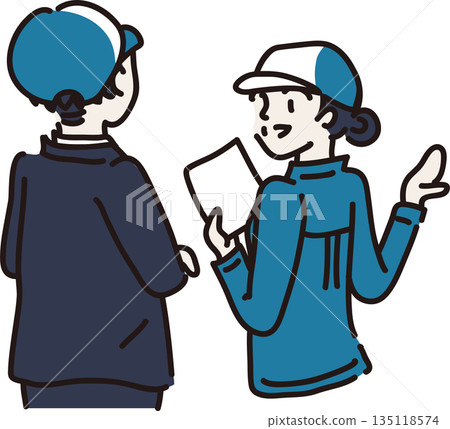 A woman wearing a hat and blue work clothes explaining to a visitor A woman wearing a hat and blue work clothes explaining to a visitor 135118574