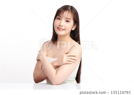 A beautiful young Asian woman with clean, fresh skin against a white background. Skincare, facial treatment, cosmetology, beauty, and spa. An elegant portrait of an Asian woman. A beautiful young Asian woman with clean, fresh skin against a white background. Skincare, facial treatment, cosmetology, beauty, and spa. An elegant portrait of an Asian woman. 135118765