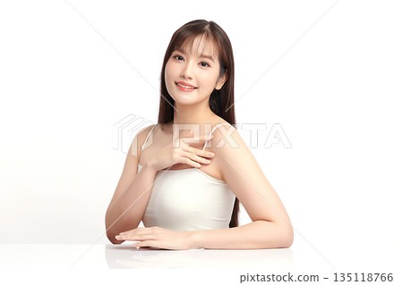 A beautiful young Asian woman with clean, fresh skin against a white background. Skincare, facial treatment, cosmetology, beauty, and spa. An elegant portrait of an Asian woman. 135118766