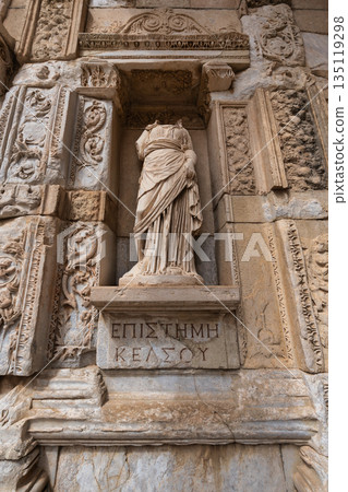 Headless statue of Episteme, personification of Knowledge, at the ancient Roman Library of Celsus, Ephesus, Turkey. 135119298