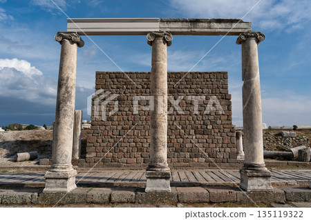 Asclepieion of Pergamon, Bergama, Turkey. Greco-Roman ruins with three columns, architrave, and stone wall Asclepieion of Pergamon, Bergama, Turkey. Greco-Roman ruins with three columns, architrave, and stone wall 135119322