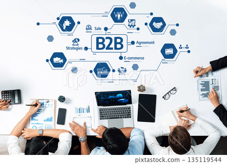 Collaborative Business Meeting with B2B Focus and Strategic Planning Elements Represented by Icons and Graphs on a Modern Workspace. Amity Collaborative Business Meeting with B2B Focus and Strategic Planning Elements Represented by Icons and Graphs on a Modern Workspace. Amity 135119544