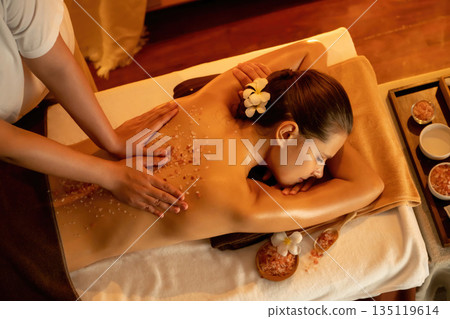 Woman customer having exfoliation treatment in luxury spa. Quiescent 135119614