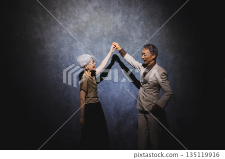 Smiling senior couple with arms crossed 135119916