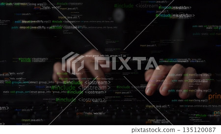 Close-Up View of a Programmer Hands Typing on a Laptop with Code and Data Streams Background in a Dark Environment xenic 135120087