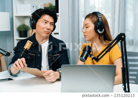 Radio influencer hosts wearing headphones with channel online. Infobahn. Radio influencer hosts wearing headphones with channel online. Infobahn. 135120213