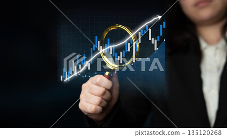Businesswoman Holding Magnifying Glass Analyzing Rising Stock Market Trend with Candlestick Chart and Graph of Financial Data in Dark Background Impute 135120268