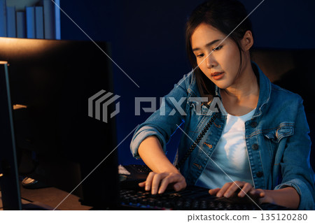Young beautiful Asian creative woman calling on phone desk. Stratagem. Young beautiful Asian creative woman calling on phone desk. Stratagem. 135120280