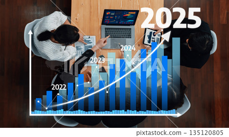 Business Meeting Overview for Strategic Planning with Team Analyzing Charts and Data for Future Growth Projections from 2022 to 2025. Amity 135120805