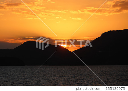 Sunset over Kotoshima Island in the Seto Inland Sea at dusk, seen from the Shodoshima Ferry Sunset over Kotoshima Island in the Seto Inland Sea at dusk, seen from the Shodoshima Ferry 135120975