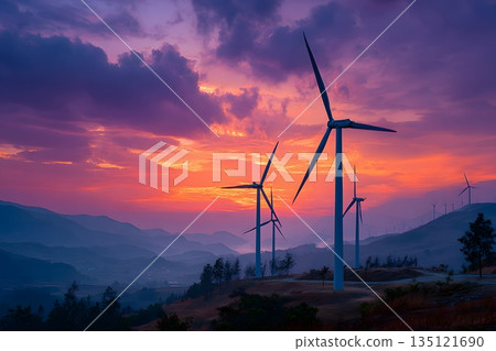 Silhouettes of wind turbines lined up against the sunset sky 135121690