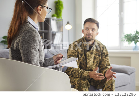 Military veteran talking about trauma and recovery with professional counselor Military veteran talking about trauma and recovery with professional counselor 135122290