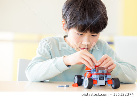 Boy learning in programming class Boy learning in programming class 135122374