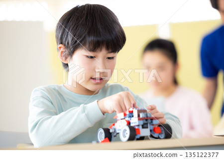 Boy learning in programming class 135122377