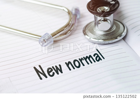 NEW NORMAL. Text on a medical card next to a pen stethoscope. Coronavirus concept. NEW NORMAL. Text on a medical card next to a pen stethoscope. Coronavirus concept. 135122502