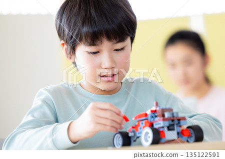 Boy learning in programming class Boy learning in programming class 135122591