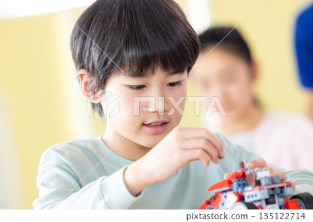 Boy learning in programming class Boy learning in programming class 135122714