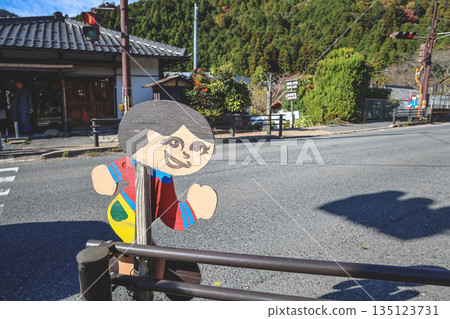 Nov 23 2025 Playful Wooden Cutout Figure On Street Corner In Quiet Japanese Town Nov 23 2025 Playful Wooden Cutout Figure On Street Corner In Quiet Japanese Town 135123731
