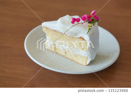 side view coconut cake, pink and purple flowers in white ceramic plate on wooden table background, dessert, food, fashion, decor, object, copy space side view coconut cake, pink and purple flowers in white ceramic plate on wooden table background, dessert, food, fashion, decor, object, copy space 135123988