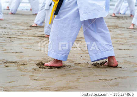 Karate training on the beach in the middle of winter Karate training on the beach in the middle of winter 135124066