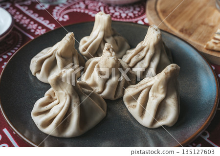 Traditional Georgian Khinkali Dumplings on a Plate 135127603