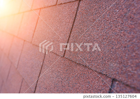 Red Bituminous Roof Shingle Texture Background with Granular Surface 135127604