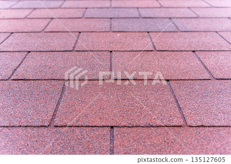 Red Bituminous Roof Shingle Texture Background with Granular Surface 135127605