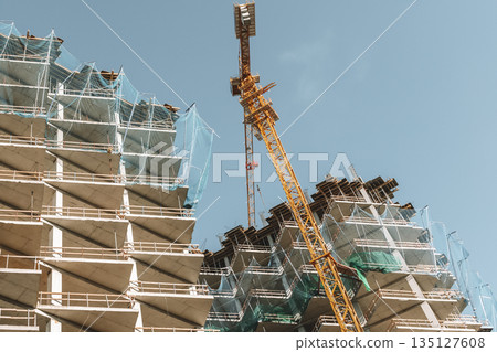 Construction of a building. Construction site with crane. Business, development, industry. Construction of a building. Construction site with crane. Business, development, industry. 135127608